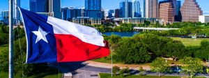 Perfect Texas flag flying in front of Austin Texas downtown skyline cityscape sunny perfect day